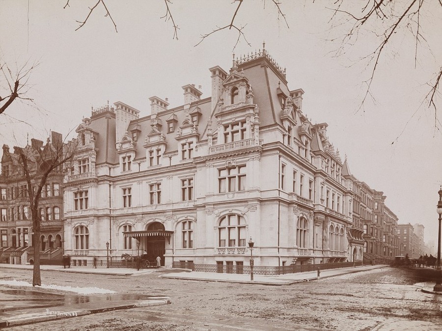 Meet the neighbors: Northeast corner of 5th Avenue and East 65th Street, dominated by the John Jacob Astor House which can be seen from the front and side. A horse-drawn carriage is seen at the 5th Avenue entrance of the house