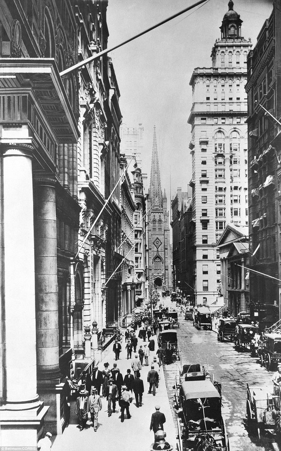 A view looking west on Wall Street about 1890 from the corner of Wall and Broad. Trinity Church is at the end of the street. To the left is the old Assay Office