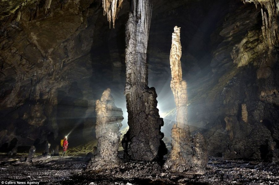 Large stalagmites at the foot of a giant ascending ramp to another level of development