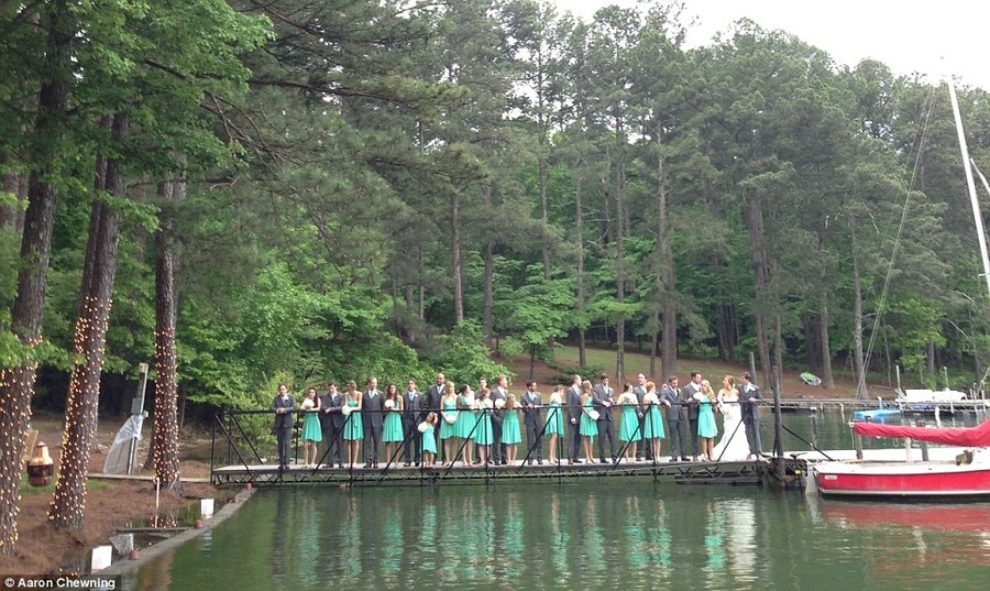 Before: An image shows the 29 members of a wedding party lining a dock, ready for photographs