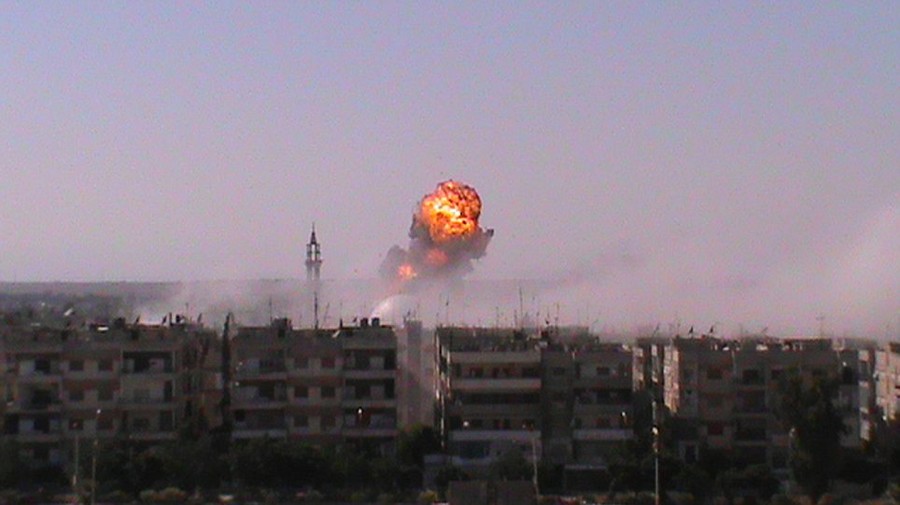Fire and smoke: Smoke and flames rise in the Khalidiyah neighbourhood of Homs after an attack by Syrian forces