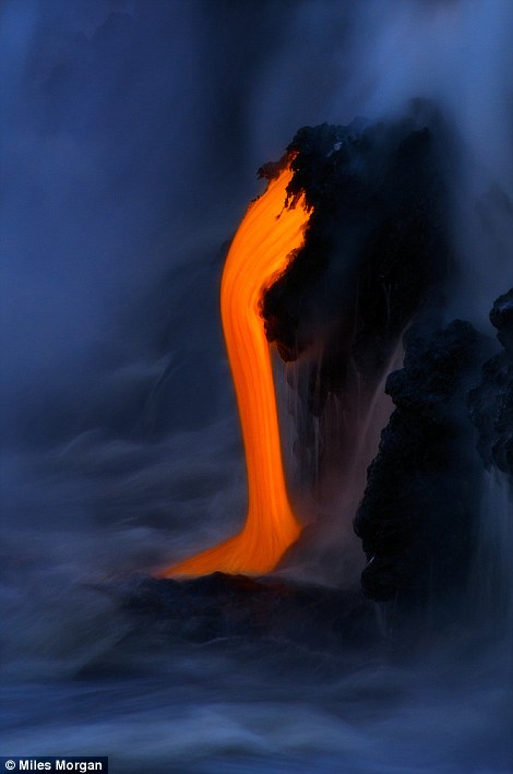 Lava from the Kilauea Volcano drips into the ocean during the ?blue hour? before dawn