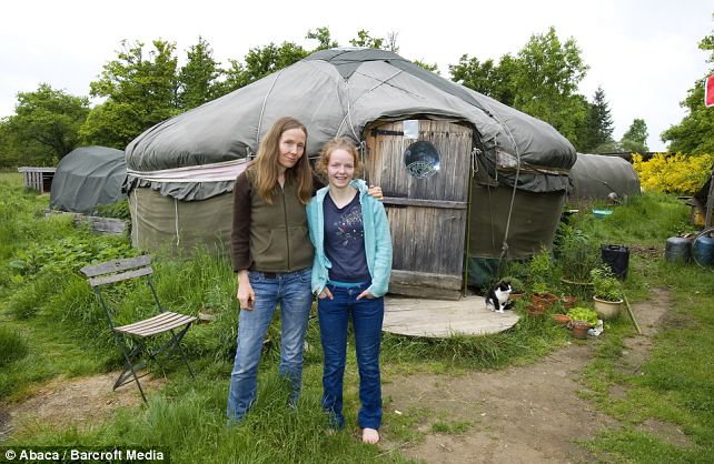 Happy: Janie Corbett and her daughter Branwen, pose in front of the yurt where they have been living for several years