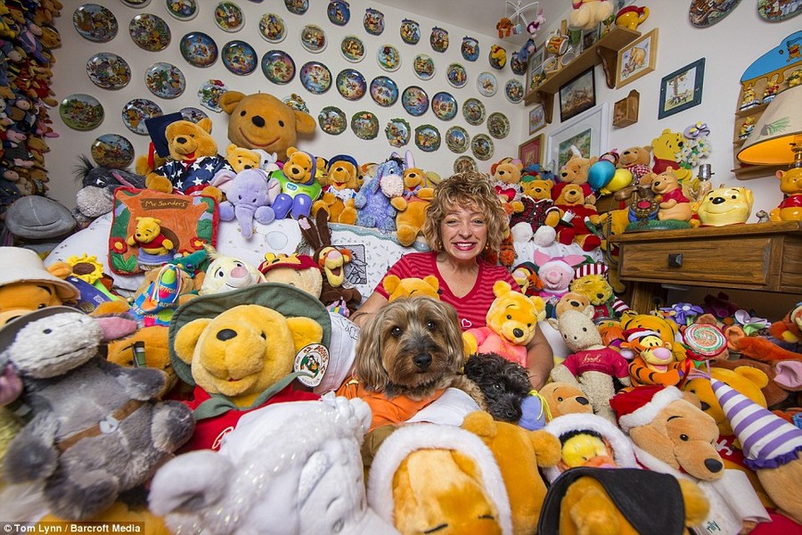 Snug as a bug: Guinness World Book of Records holder Deb Hoffmann pictured surrounded by her Winnie the Pooh collection at her home in Waukesha, Wisconsin