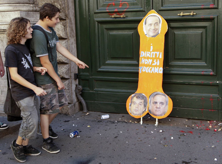 Демонстранты изучают антиправительственную агитацию © Reuters/REMO CASILLI