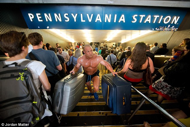 'Business Travel': Body-builder Vincent Luzzolino definitely doesn't need any help carrying his bags from the train station to the taxi queue 