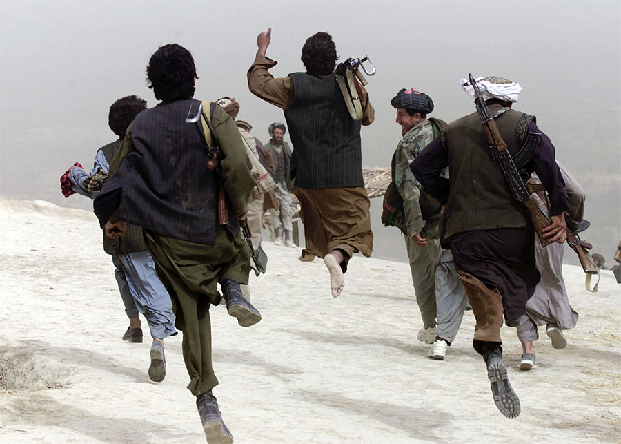Солдаты афганского Северного альянса возвращаются с линии фронта после боя. © Gleb Garanich/Reuters