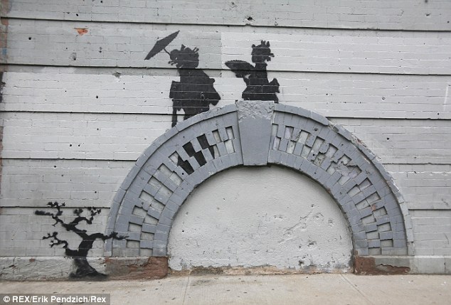 Banksy's newest work uses a brick archway on the side of a building in Williamsburgh, Brooklyn, to stand in for a bridge