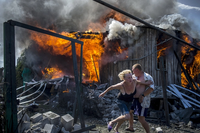 Местные жители спасаются от пожара в доме 