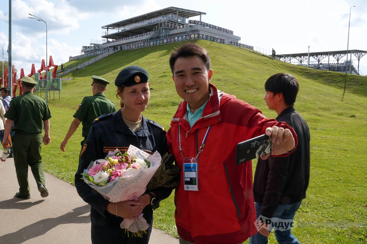 Китайский журналист фотографируется с девушкой-танкисткой Китайский журналист фотографируется с девушкой-танкисткой