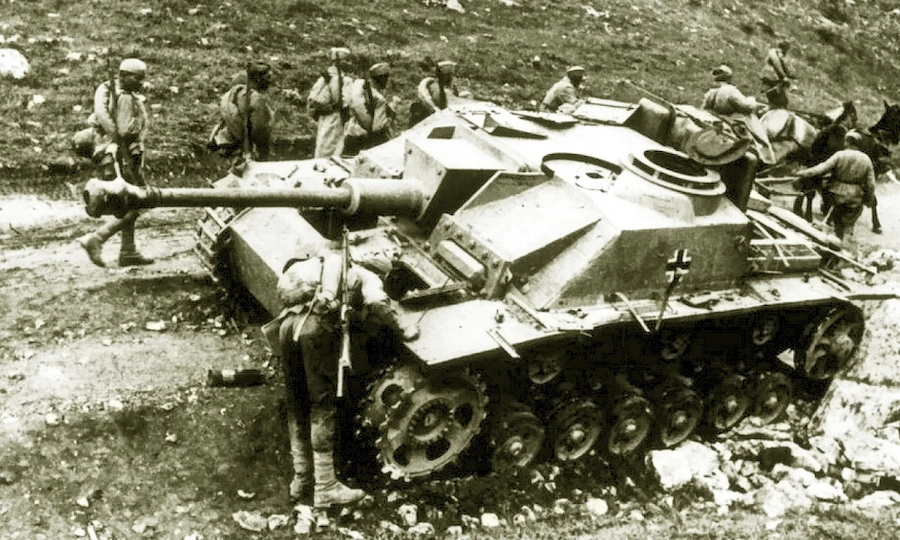 Красноармейцы проходят мимо подбитой и брошенной у дороги немецкой самоходки StuG 40. Крым, весна 1944 года